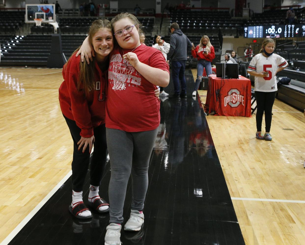 Emmy Sheldon hugs her sister Jacy Sheldon after a game in 2021.