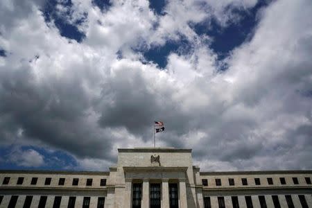 Flags fly over the Federal Reserve Headquarters on a windy day in Washington, U.S., May 26, 2017. REUTERS/Kevin Lamarque