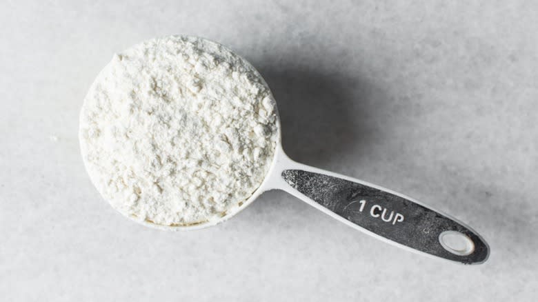 Metal measuring cup of flour