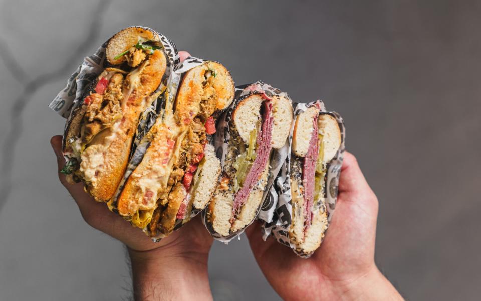 B Bagel's chicken shawarma bagel with houmous, tahini, tomato, pickles and parsley (left) and a shaved beef pastrami bagel with mustard mayo and pickle (right)