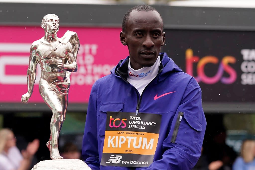 Men’s race winner Kelvin Kiptum of Kenya holds a trophy together with women’s race winner Sifan Hassan, unseen, of the Netherlands, after the London Marathon in London on April 23, 2023. (AP Photo/Alberto Pezzali, File)
