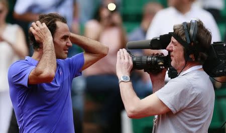 Tennis - French Open - Roland Garros, Paris, France - 27/5/15 Men's Singles - Switzerland's Roger Federer with a cameraman during the second round Action Images via Reuters / Jason Cairnduff Livepic