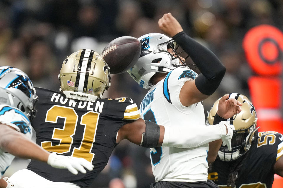New Orleans Saints safety Jordan Howden forces a fumble by Carolina Panthers quarterback Bryce Young during the first half of an NFL football game in New Orleans, Sunday, Dec. 10, 2023. (AP Photo/Gerald Herbert)