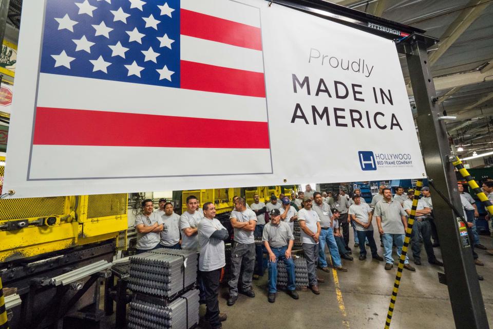 Workers at the Hollywood Bed Frame Company attend an event to mark the company's upcoming expansion which will double the manufacturer's workforce, adding 100 new local jobs, at the company's factory in Commerce, California, seven miles (11 km) southeast from downtown Los Angeles, April 14, 2017. Hollywood Bed Frame says it is one of a number of American companies benefiting from a commitment Walmart made last year to source an additional $250 billion in products made, assembled or grown in the US. / AFP PHOTO / Robyn Beck        (Photo credit should read ROBYN BECK/AFP/Getty Images)