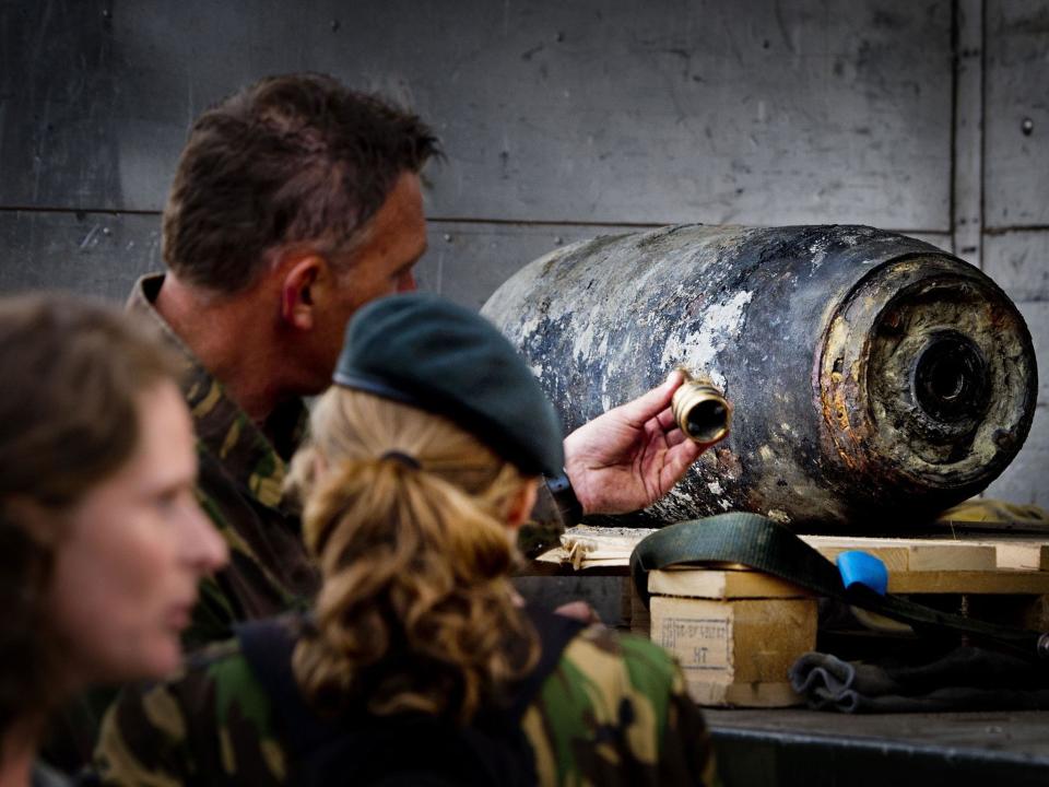 Members of the Dutch Explosive Ordnance Disposal unit stand next to a 500-pound bomb from World War II in Wannenaar, the Netherlands (file image): ROBIN UTRECHT/AFP/Getty Images