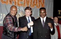 <p>George Foreman, Donald Trump and Evander Holyfield pose during a press conference to promote their upcoming fight on April 19, 1991 in Atlantic City, N.J. <i>(Photo: The Ring Magazine/Getty Images)</i> </p>