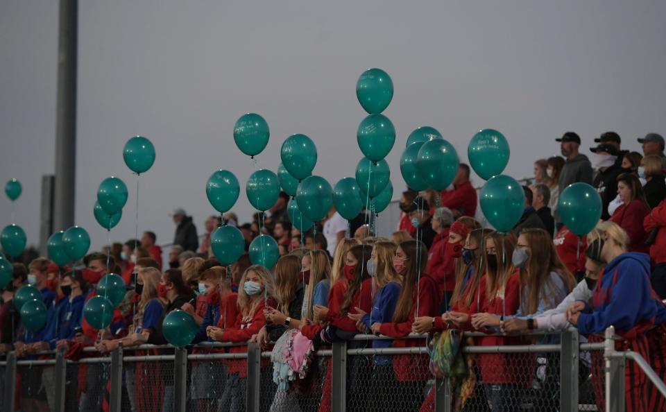 Gilbert fans release balloons in honor of Henry Owen before the football game against Ballard on Friday, Sept. 18, 2020, in Alleman, Iowa.