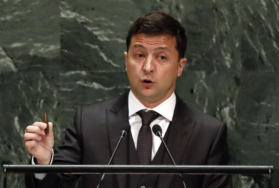 Ukraine's President Volodymyr Zelenskiy holds a bullet as he addresses the 74th session of the United Nations General Assembly, Wednesday, Sept. 25, 2019. (AP Photo/Richard Drew)