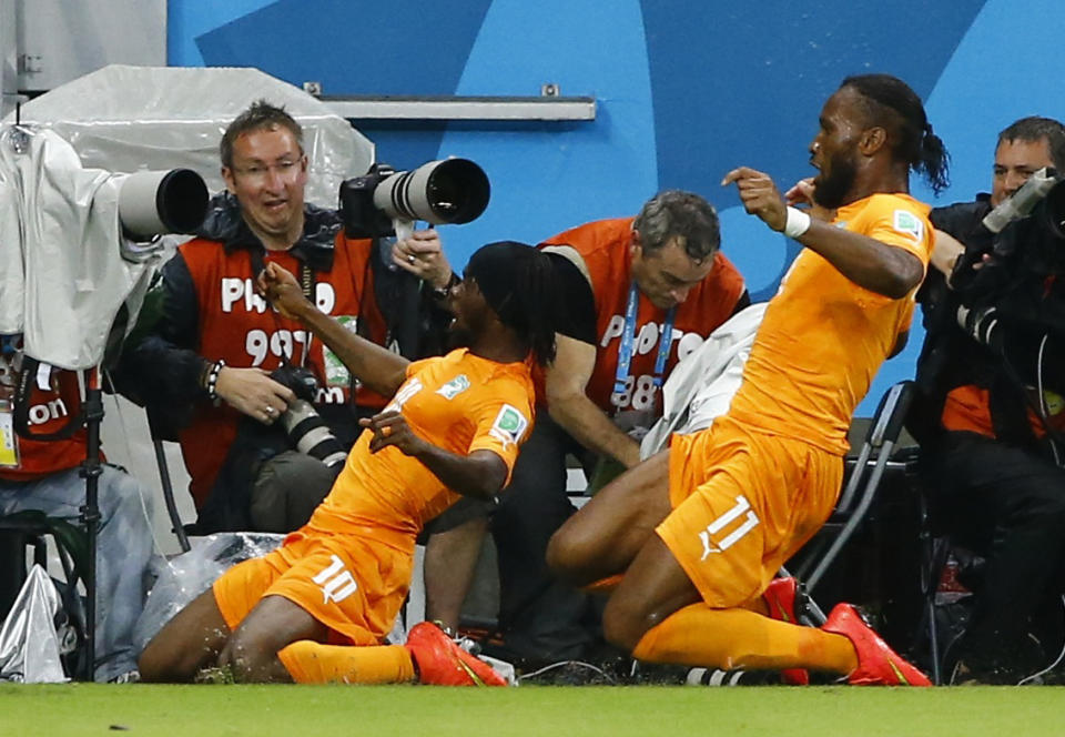 Ivory Coast's Gervinho (L) and Didier Drogba celebrate a goal by teammate Wilfried Bony against Japan during their 2014 World Cup Group C soccer match at the Pernambuco arena in Recife, June 14, 2014. REUTERS/Stefano Rellandini