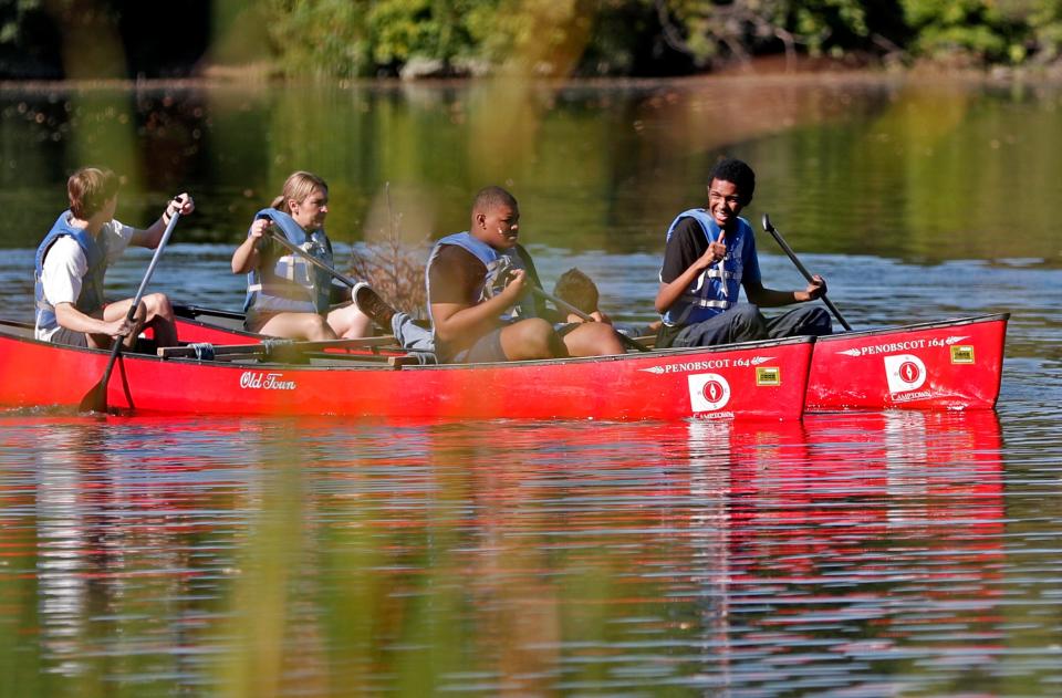 Lawrence North High School students and staff canoe in bright red canoes as they participate in Camptown adventure activities Friday, Oct. 1, 2021 at Fort Benjamin Harrison State Park. The nonprofit uses outdoor adventures to teach teens coming from difficult backgrounds the necessary life skills they need to survive. The different challenges and obstacles they face are meant to help them overcome their fears, recognize their strengths and learn to face adversity.