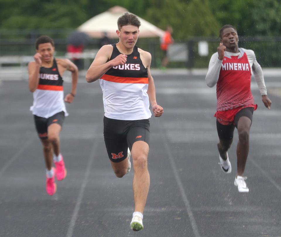 Marlington's Logan Kuhn (left) and Cameron Evanich (center) and Minerva's Nate Green run the boys 200-meter dash at Saturday's Eastern Buckeye Conference Track and Field Championships. Evanich won the race. It was one of four wins for the freshman on the day.