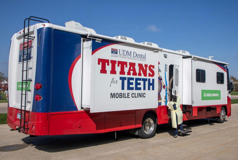 April Kotermanski, manager of the Titans for Teeth Mobile Clinic, opens the mobile clinic's door parked at the Munger Elementary-Middle School in Detroit on April 26, 2023.