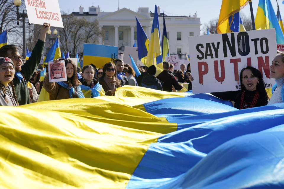 People take part in a protest against the Russian invasion of Ukraine outside the White House in Washington, Sunday, Feb. 27, 2022. (AP Photo/Patrick Semansky)