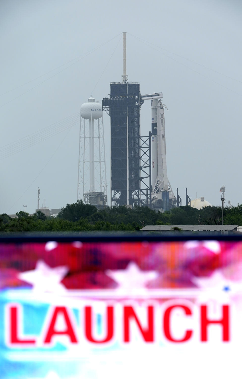 The SpaceX Falcon 9, with the Crew Dragon spacecraft on top of the rocket, sits on Launch Pad 39-A Monday, May 25, 2020, at Kennedy Space Center, Fla. Two astronauts will fly on the SpaceX Demo-2 mission to the International Space Station scheduled for launch on May 27. (AP Photo/David J. Phillip)