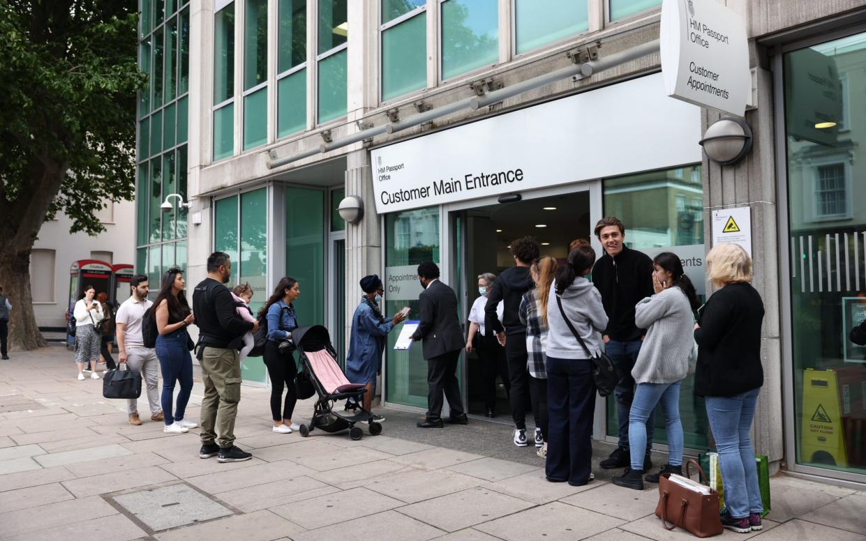 People line up outside HM Passport Office in London, UK - Hollie Adams