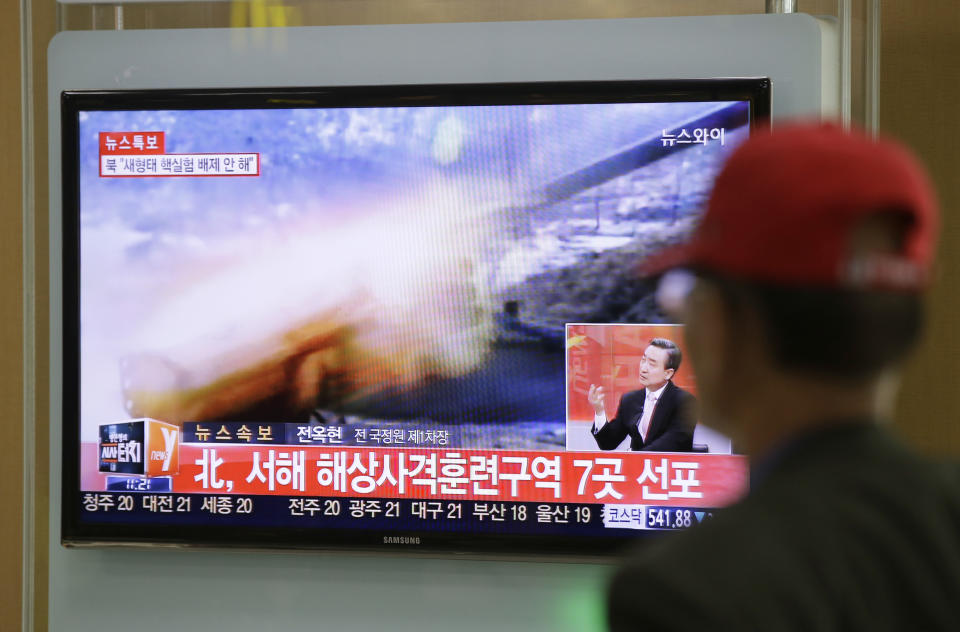 A man watches a television news program reporting about North Korea's plan to conduct live-fire drills, at a Seoul train station in Seoul, South Korea, Monday, March 31, 2014. South Korea said North Korea has announced plans to conduct live-fire drills near the rivals' disputed western sea boundary. Seoul's Defense Ministry said North Korea says it will conduct firing drills in seven areas north of the sea boundary. Seoul responded that it will strongly react if provoked. The writing reads "North, Firing drills in seven areas western sea." (AP Photo/Lee Jin-man)