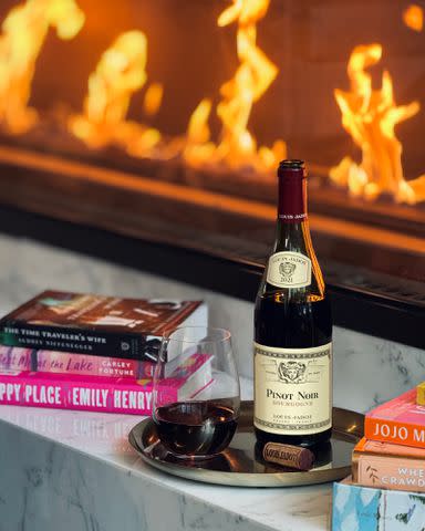 <p>Erin Krakow/Maison Louis Jadot</p> A bottle of Louis Jadot wine with books