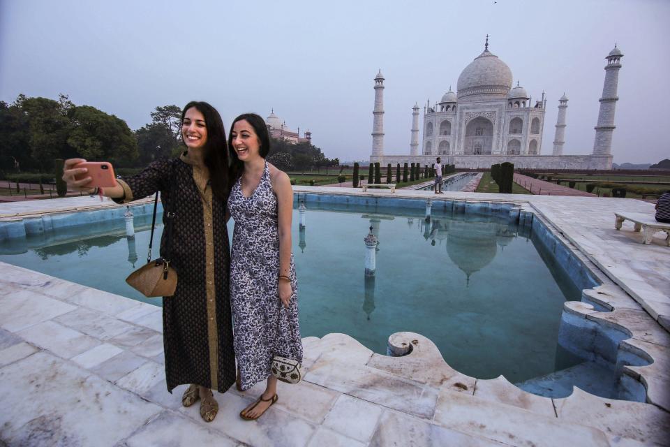 Tourists take selfies at the historic Taj Mahal, after the monument reopened for public during ‘Unlock 4’.