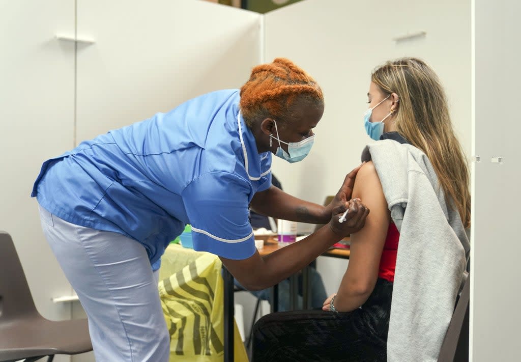 Nurse Marvis Birungi gives a Covid vaccine to Oxford Brookes University student Eleanor Seddon in a pop-up clinic at the university’s Headington Campus (Steve Parsons/PA) (PA Wire)