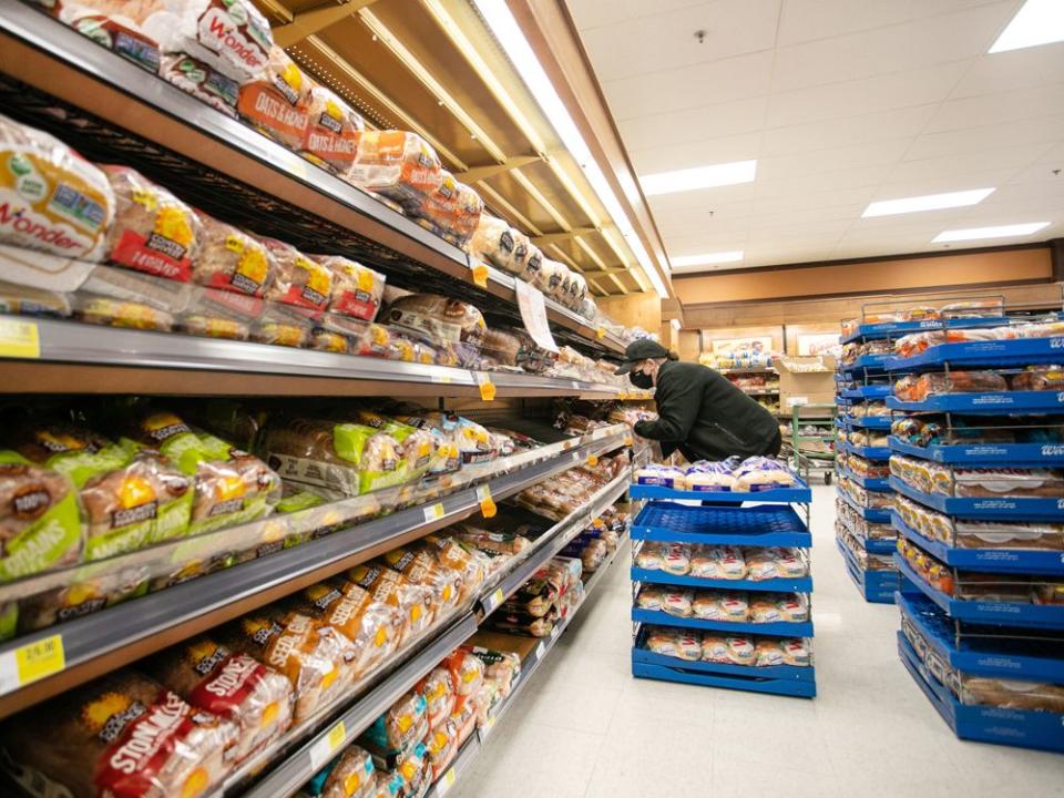  A worker restocks shelves in the bakery and bread aisle at an Atlantic Superstore grocery in Halifax.