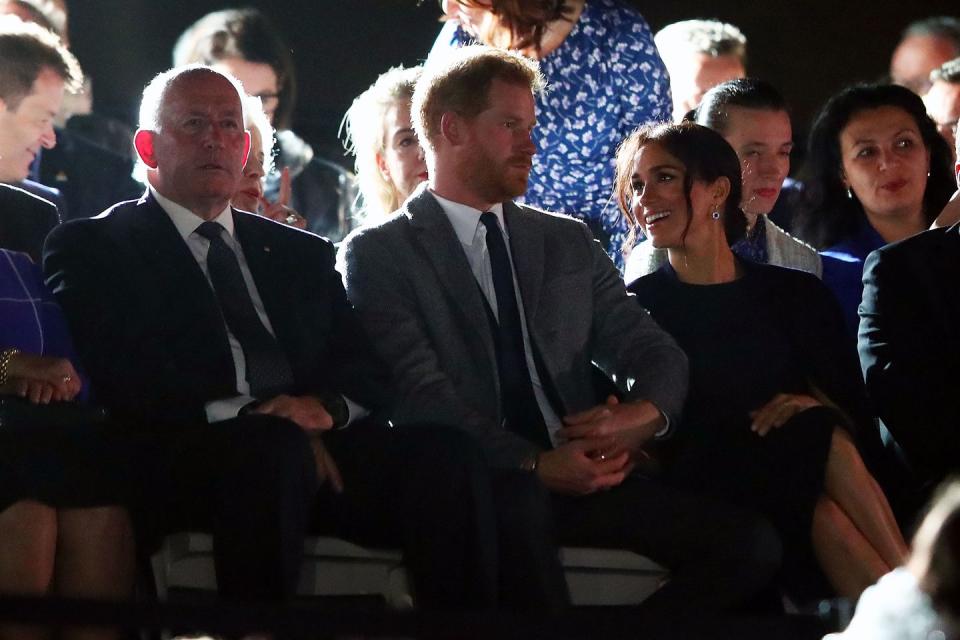 <p>Meghan can't stop smiling as Harry takes her hand in his.</p>