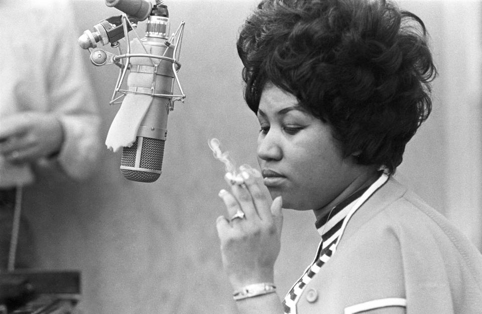 Smoking a&nbsp;cigarette as she works in the studio by a microphone at Muscle Shoals Studios in 1969 in Muscle Shoals, Alabama.