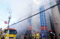<p>Firefighters inspects a burnt hospital after a fire on Jan. 26, 2018 in Miryang, South Korea. (Photo: Kyungnam Shinmun via Getty Images) </p>