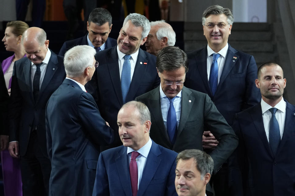 Austria's Chancellor Karl Nehammer, center, speaks with Latvia's Prime Minister Krisjanis Karins, center left, during a group photo during an EU Summit at Prague Castle in Prague, Czech Republic, Friday, Oct 7, 2022. European Union leaders converged on Prague Castle Friday to try to bridge significant differences over a natural gas price cap as winter approaches and Russia's war on Ukraine fuels a major energy crisis. (AP Photo/Petr David Josek)