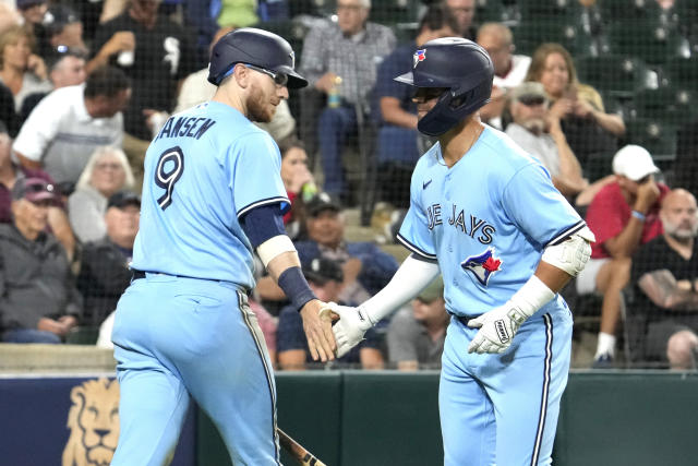 Toronto Blue Jays' Whit Merrifield, left, celebrates with third