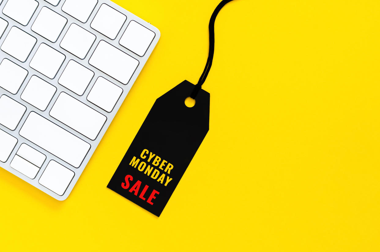 Black price tag with wireless keyboard for online shopping on yellow background. Cyber Monday concept.