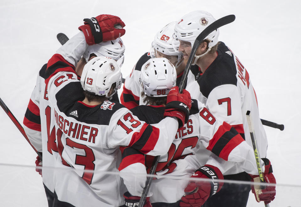 New Jersey Devils' Jack Hughes (86) celebrates with teammates after scoring against the Montreal Canadiens during the second period of an NHL hockey game, Tuesday, Nov. 15, 2022 in Montreal. (Graham Hughes/The Canadian Press via AP)