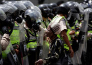 <p>Demonstrator stands next to riot police during rally against Venezuela’s President Nicolas Maduro in Caracas, Venezuela May 1, 2017. (Photo: Marco Bello/Reuters) </p>