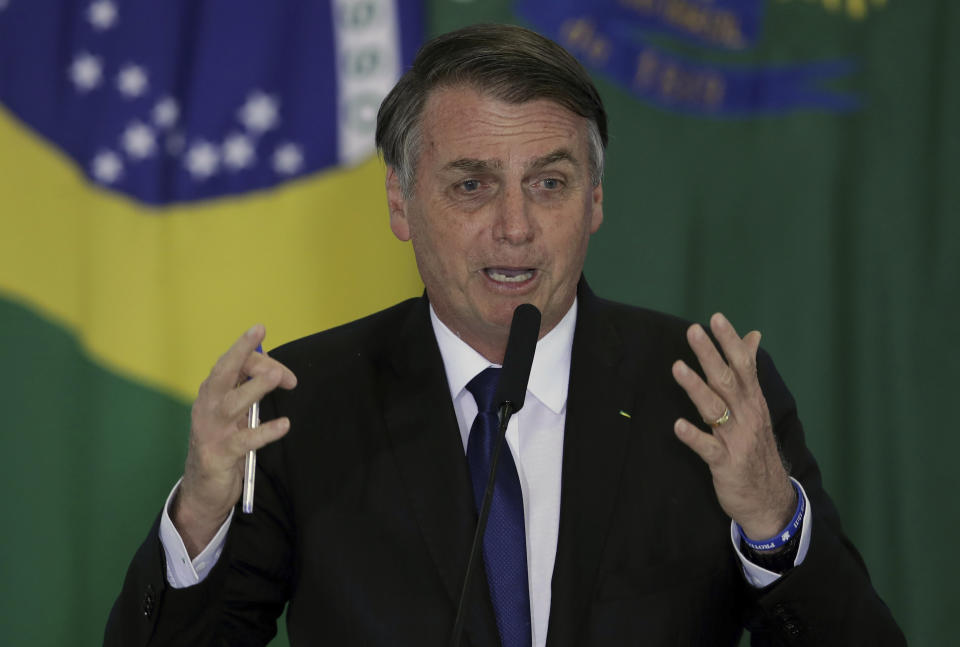 Brazil's President Jair Bolsonaro speaks during a ceremony where he signed a second decree that eases gun restrictions, during the signing ceremony at Planalto presidential palace in Brasilia, Brazil, Tuesday, May 7, 2019. The decree opens Brazil’s market to guns and ammunition made outside of Brazil according to a summary of the decree. Gun owners can now buy between 1,000 -5,000 rounds of ammunition per year depending on their license, up from 50 rounds. Lower-ranking military members can now carry guns after 10 years of service. (AP Photo/Eraldo Peres)