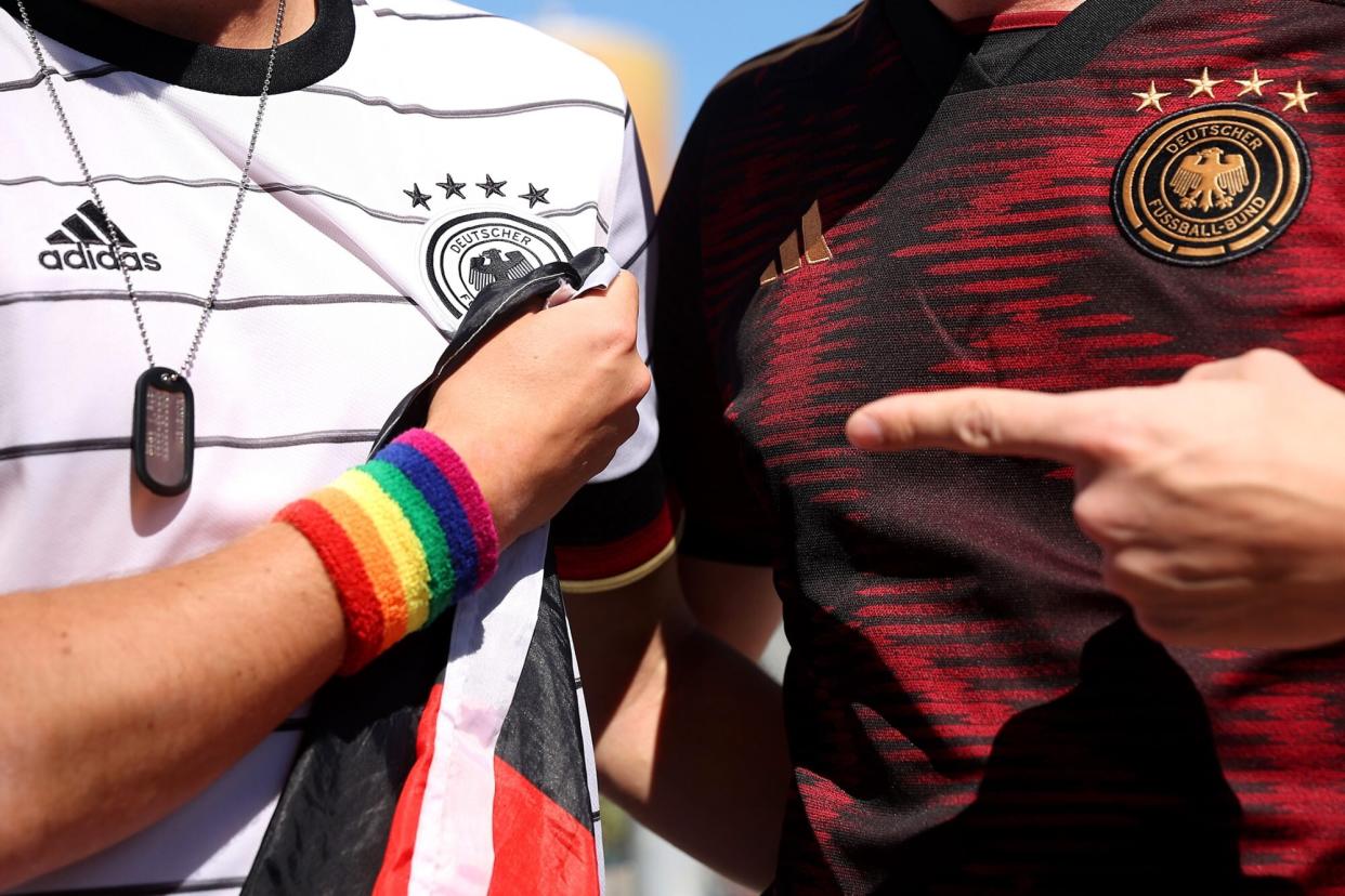 Germany fans pose for a photo as they wear a Rainbow wristband as the German Interior Minister Visits DFB's Mobile Fan Embassy on November 22, 2022 in Doha, Qatar.