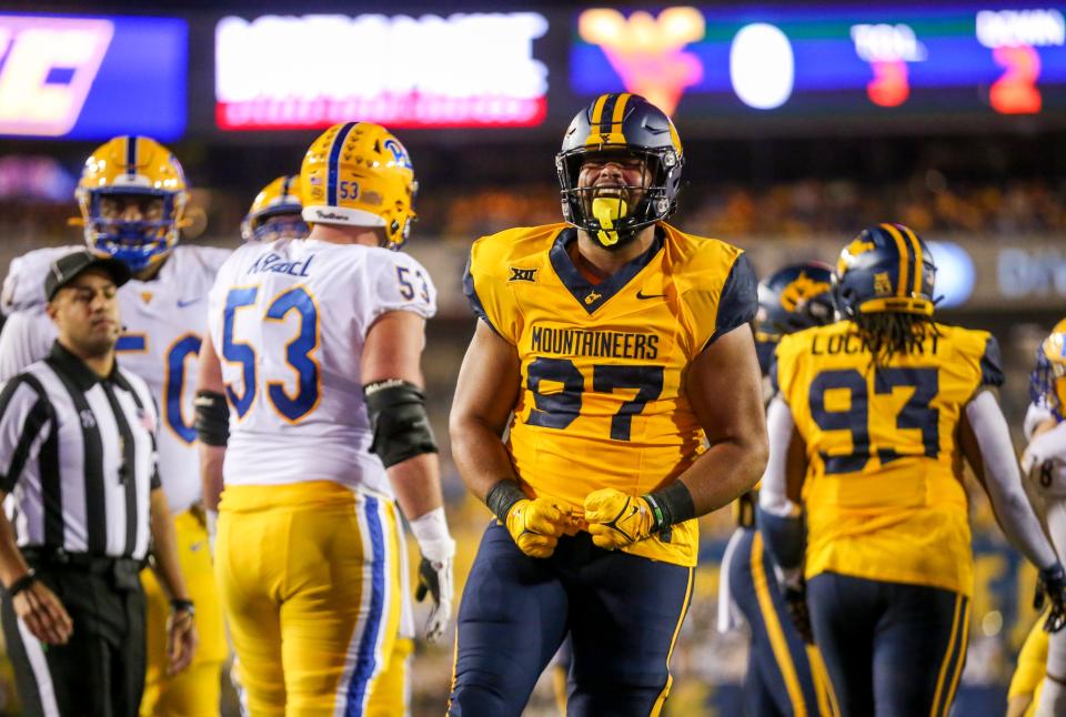 West Virginia Mountaineers defensive lineman Jalen Thornton (97) reacts after a defensive stop during the second quarter against the Pittsburgh Panthers at Mountaineer Field at Milan Puskar Stadium.