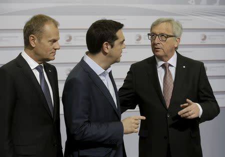 European Council President Donald Tusk (L) looks on as Greece's Prime Minister Alexis Tsipras (C) speaks to European Commission President Jean-Claude Juncker before the Eastern Partnership Summit session in Riga, Latvia, May 22, 2015. REUTERS/Ints Kalnins