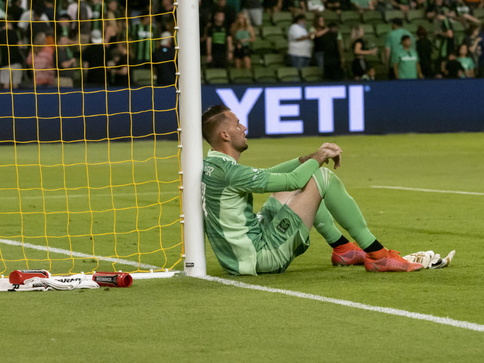 Austin FC goalkeeper Brad Stuver sits against the goal after a loss to the San Jose Earthquakes in an MLS soccer match, Saturday, Sept. 18, 2021, in Austin, Texas. (AP Photo/Michael Thomas)