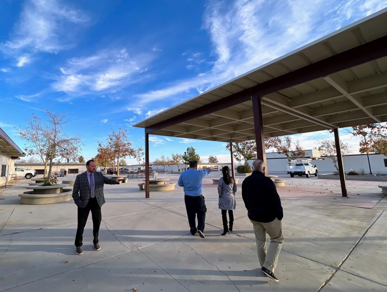 Victor Valley Union High School District Superintendent Carl Coles, left, and other district administrators evaluate the former Cobalt Middle School site in Victorville earlier this winter. The campus will become a new middle school this summer.