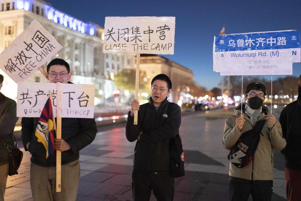 People protest at Freedom Plaza in Washington, Sunday, Dec. 4, 2022, in solidarity with the ongoing protests against the Chinese government's continued zero-COVID policies. (AP Photo/Jose Luis Magana)