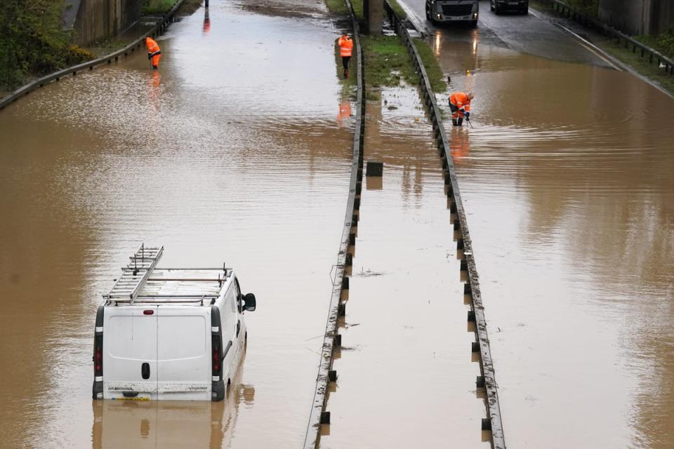 A car is stranded in floodwater on the A189 Spine Road near Blyth, Northumberland, in the wake of Storm Kathleen (PA)