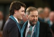 Canada's Liberal leader Justin Trudeau (L) and Official Opposition leader Thomas Muclair arrive for the state funeral of Canada's former finance minister Jim Flaherty in Toronto, April 16, 2014.