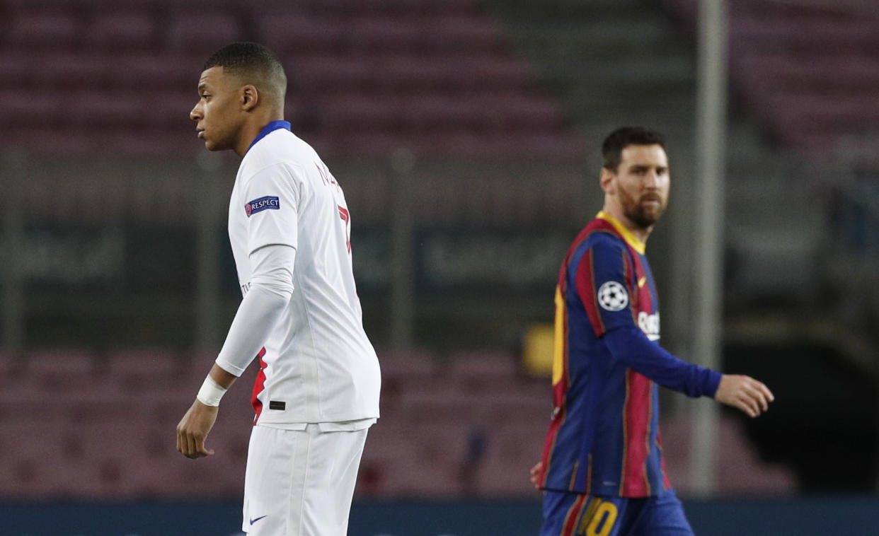 Soccer Football - Champions League - Round of 16 First Leg - FC Barcelona v Paris St Germain - Camp Nou, Barcelona, Spain - February 16, 2021  Barcelona's Lionel Messi and Paris St Germain's Kylian Mbappe on the pitch before the match REUTERS/Albert Gea