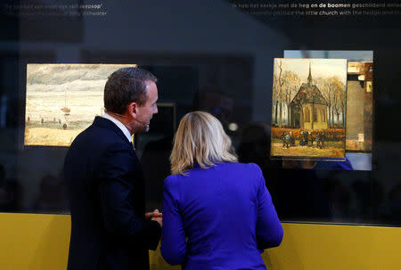 Museum director Axel Ruger and Dutch Minister of Education, Culture and Science Jet Bussemaker reveal two recovered paintings by Vincent van Gogh, which were stolen from the museum in 2002, at the van Gogh Museum in Amsterdam, Netherlands March 21, 2017. REUTERS/Michael Kooren