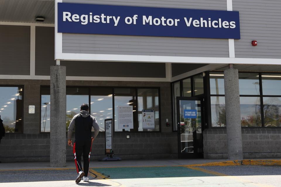 A man walks to the Commonwealth of Massachusetts Registry of Motor Vehicles office in Lawrence, Mass., Tuesday, May 5, 2020. (AP Photo/Charles Krupa)