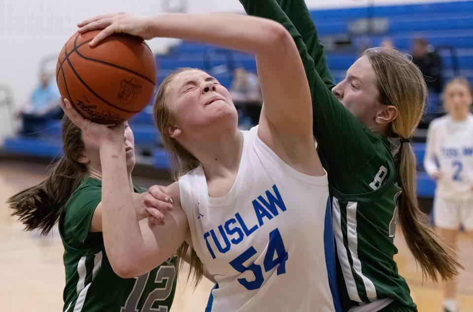 Tuslaw’s Breanna McCabe is fouled by Lake Catholic’s Maddie Cox in a Division III sectional semi, Wednesday, Feb. 21, 2024.
