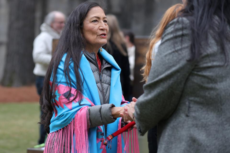 U.S. Secretary of the Interior Deb Haaland talks with people Friday at the Field of Empty Chairs after the ceremony at the Oklahoma City National Memorial & Museum.