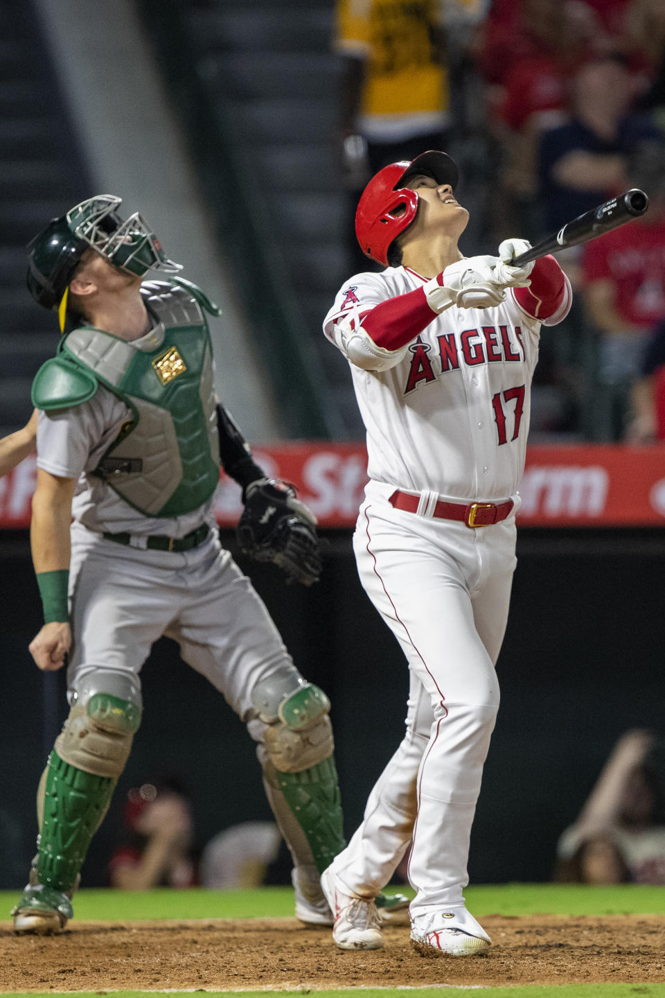 Los Angeles Angels' Shohei Ohtani, right, looks up with Oakland Athletics catcher Sean Murphy as Ohtani flies out during the fifth inning of a baseball game in Anaheim, Calif., Wednesday, Sept. 28, 2022. (AP Photo/Alex Gallardo)
