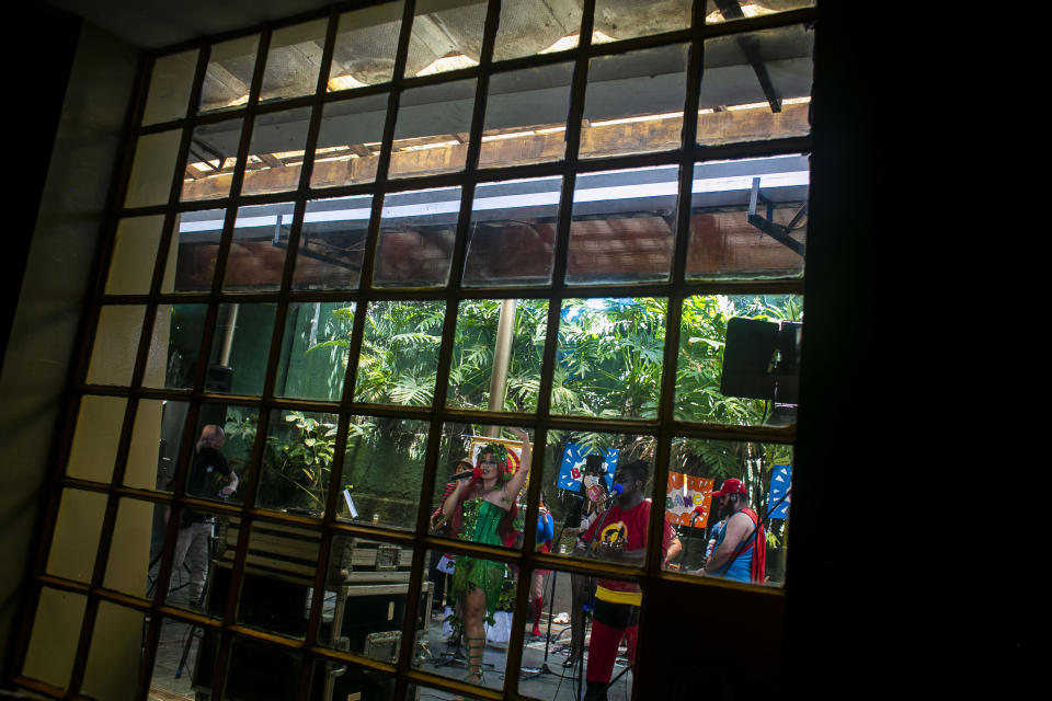 Musicians of the "Desliga da Justica" street band perform in Rio de Janeiro, Brazil, Sunday, Feb. 14, 2021. Their performance was broadcast live on social media for those who were unable to participate in the carnival due to COVID restrictions after the city's government officially suspended Carnival and banned street parades or clandestine parties. (AP Photo/Bruna Prado)