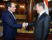 Russian Prime Minister Dmitry Medvedev, right, shakes hands with Egyptian President Abdel-Fattah el-Sissi during their meeting in Moscow, Russia, Tuesday, Oct. 16, 2018. Egyptian officials say the visit will enhance economic and trade ties and include discussions to advance the construction of the nuclear plant Russia is building on Egypt's Mediterranean coast. (Dmitry Astakhov, Sputnik, Kremlin Pool Photo via AP)