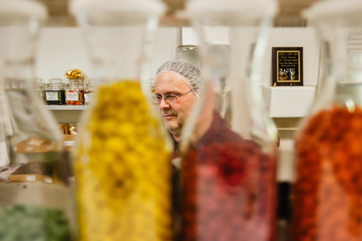 John Gibbs looks over of the products in Eiler Candy Shop in Dover, which he co-owns.